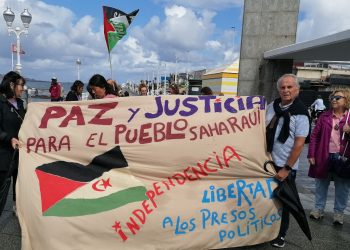 Banderas saharauis al viento y la lluvia en el paseo de San Lorenzo en Xixón